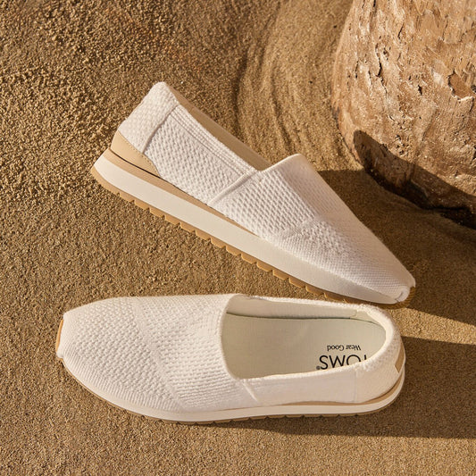 Close up laydown image of the white knit Resident Plus slip on sneakers