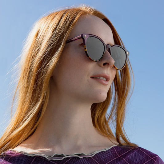 Women's Aaryn Handcrafted Sunglasses Collection model wearing Orchid Tort Colorway