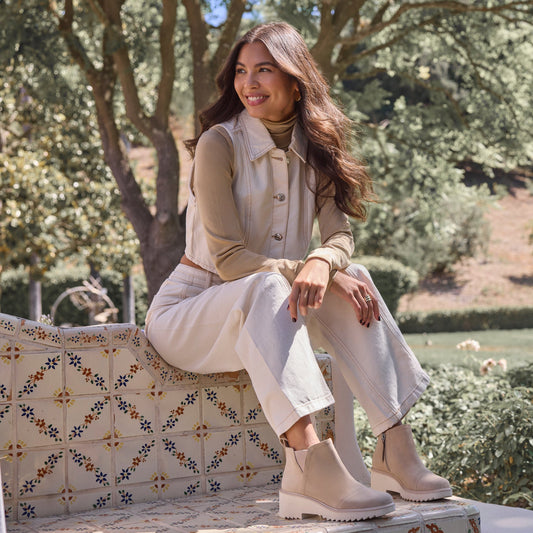 On figure image of the oatmeal suede Maude wedge bootie