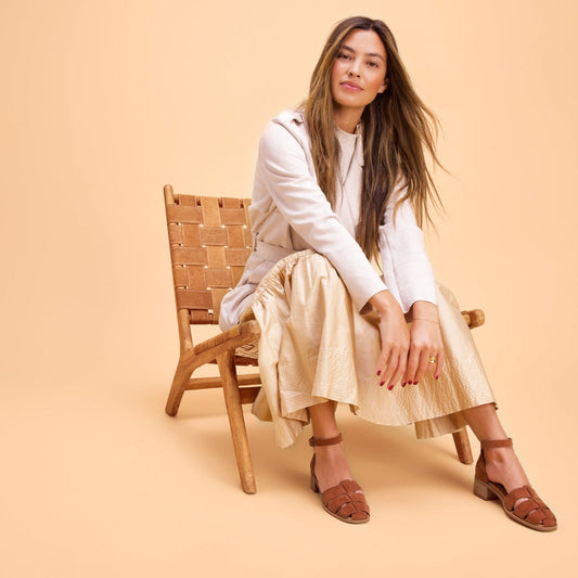On figure lifestyle image of the Amber Brown Kid Suede Jaclyn Fisherman sandals