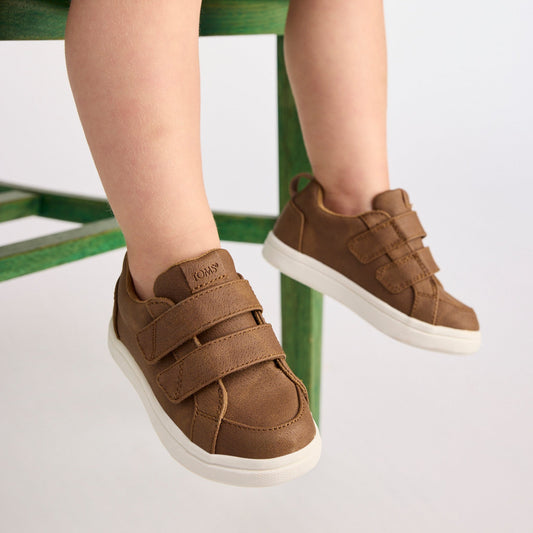 On figure image of the Cruz Double Strap Toddler Shoe in Toffee Microsuede