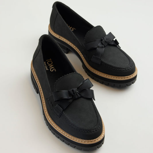 Laydown detail image of the black Cara loafer with bow detail