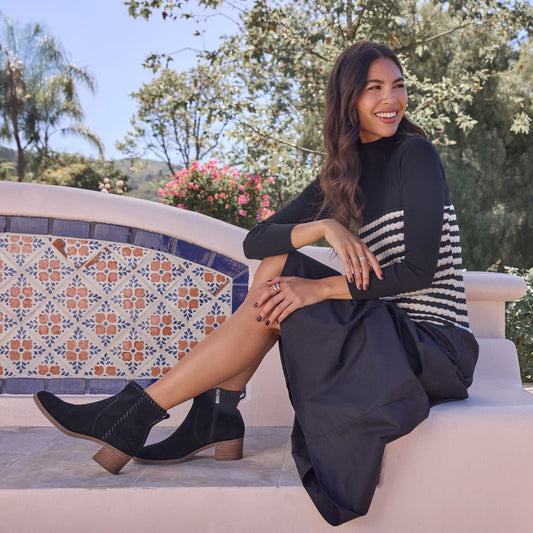 On figure image of the black suede Delilah Women's heeled boot