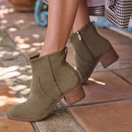 On figure image of olive green Delilah heeled boot