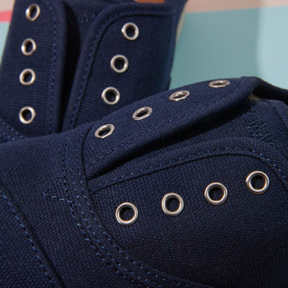 Up close detail shot of the youth navy Cordones Plus sneaker