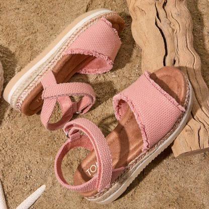 Laydown image on the beach of the Youth Kids Diana sandal in Bloom