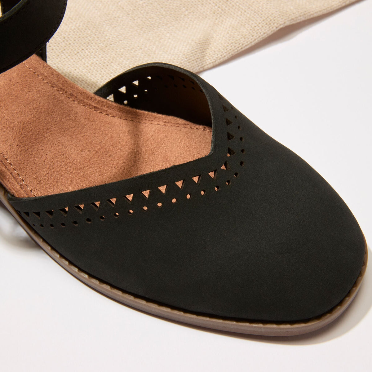 Close up detail image of the black perforated leather Jaclyn heel