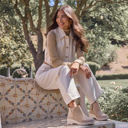 On figure image of the oatmeal suede Maude wedge bootie
