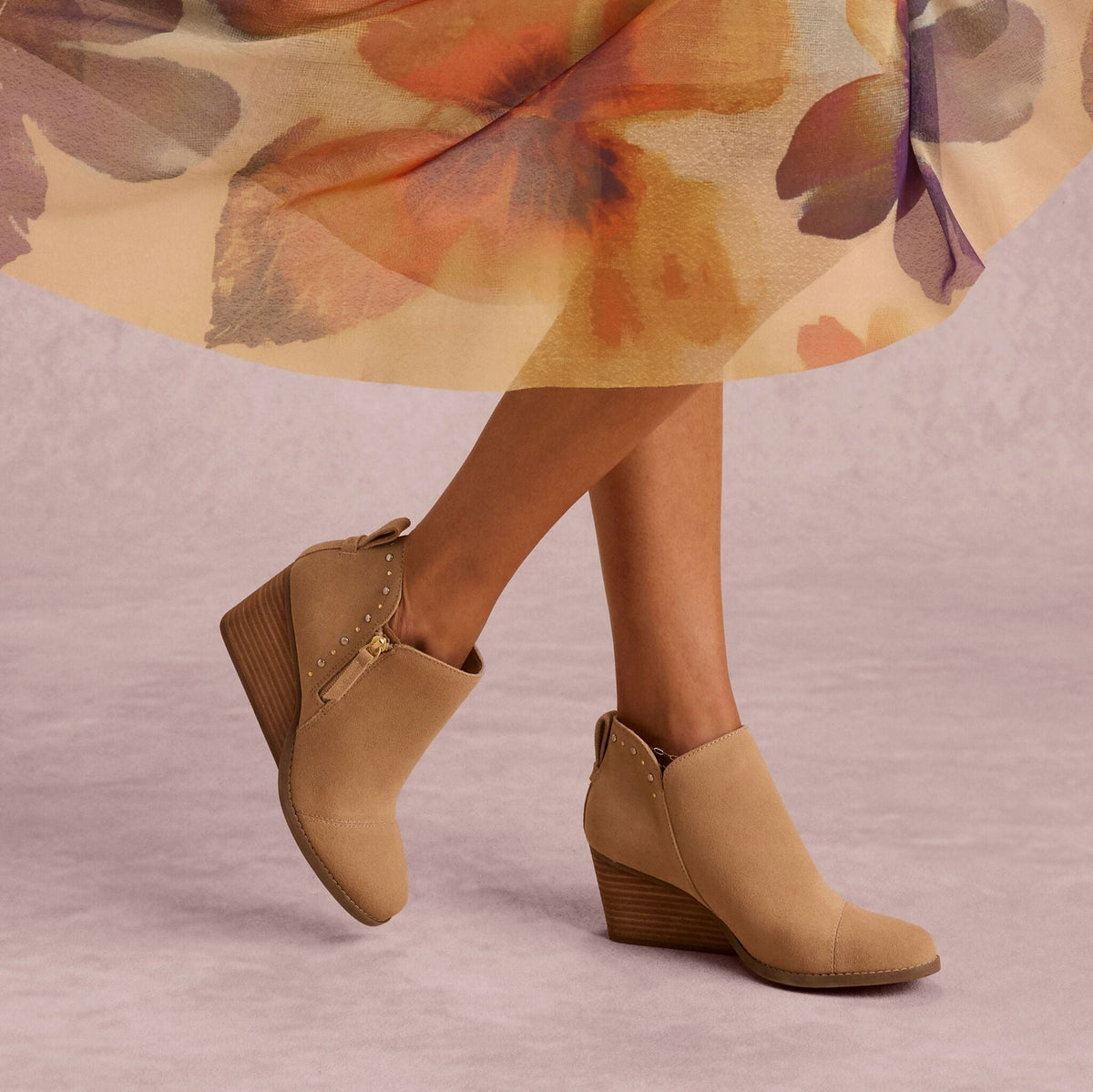 On model image of the Womens Goldie Wedge Ankle Bootie Taupe Suede with Studs